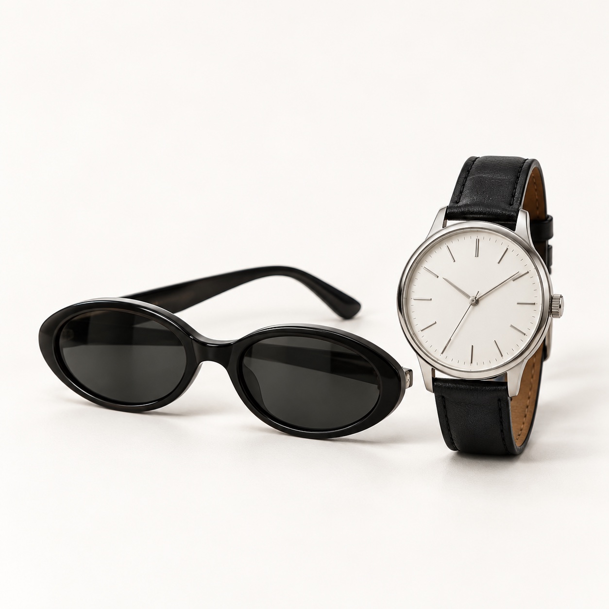 Black sunglasses and a simple silver wristwatch.